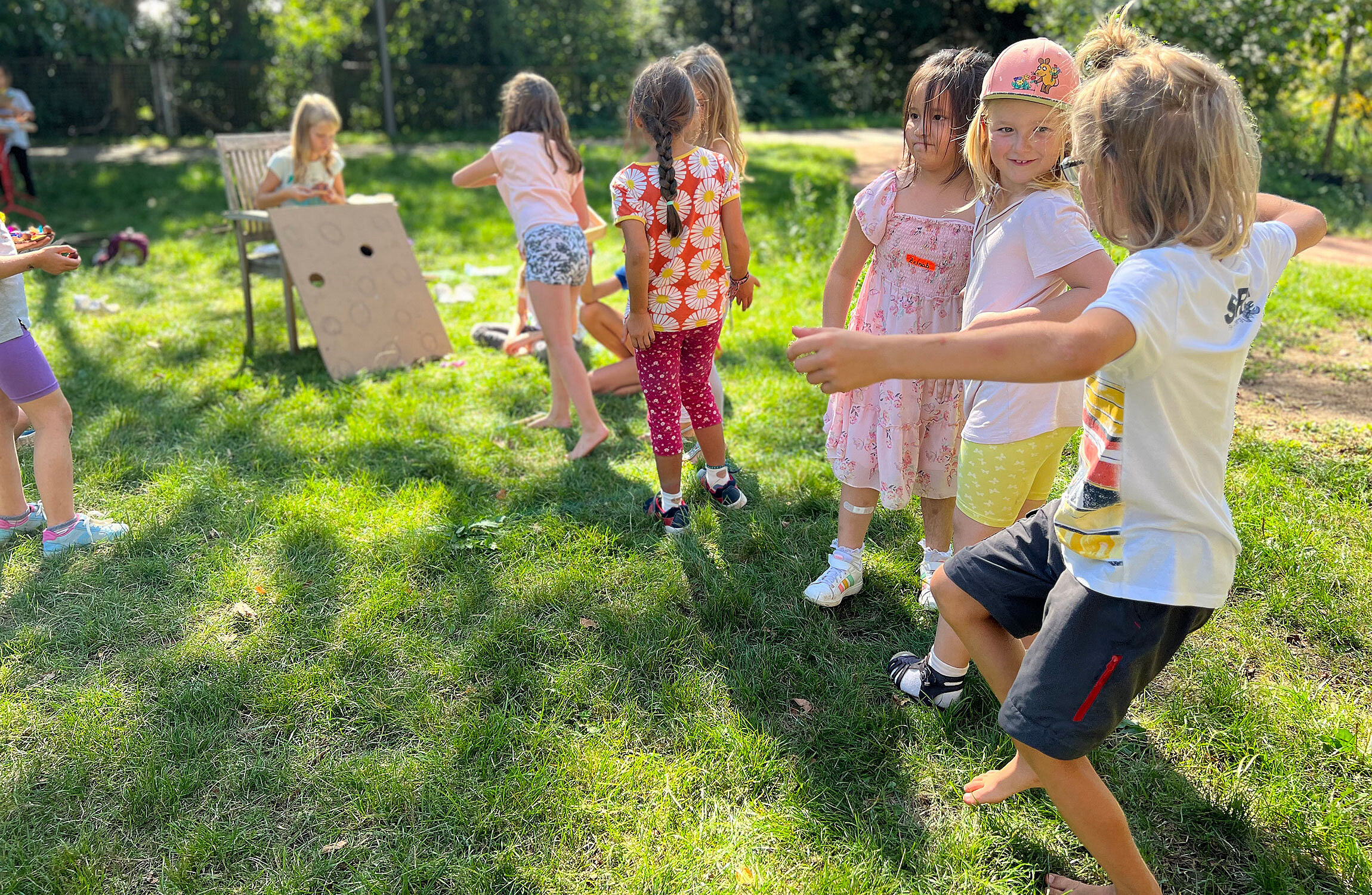 Kinder stehen in einer Schlage um an einem Brettspiel mitzuspielen